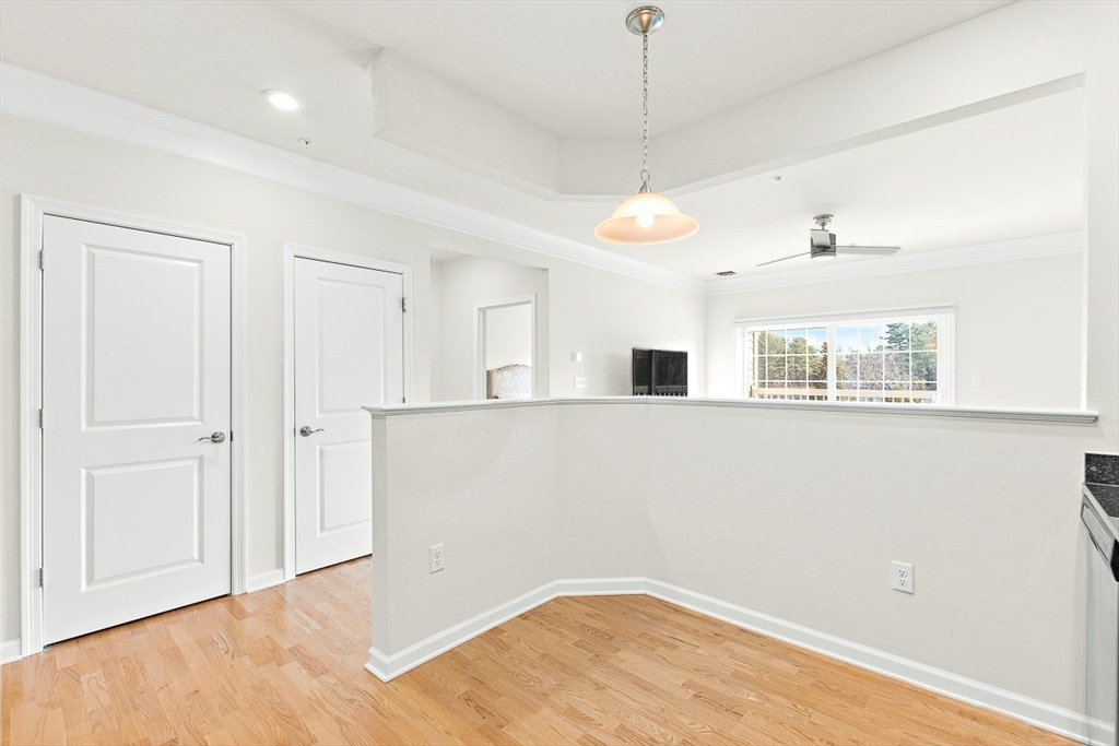 36 Abigail Way, Unit 3003 Reading, MA 01867 - Photo 15 of 42 a view of empty room with wooden floor and fan