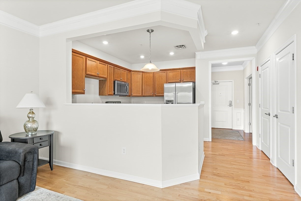36 Abigail Way, Unit 3003 Reading, MA 01867 - Photo 16 of 42 a view of a hallway with wooden floor and cabinet