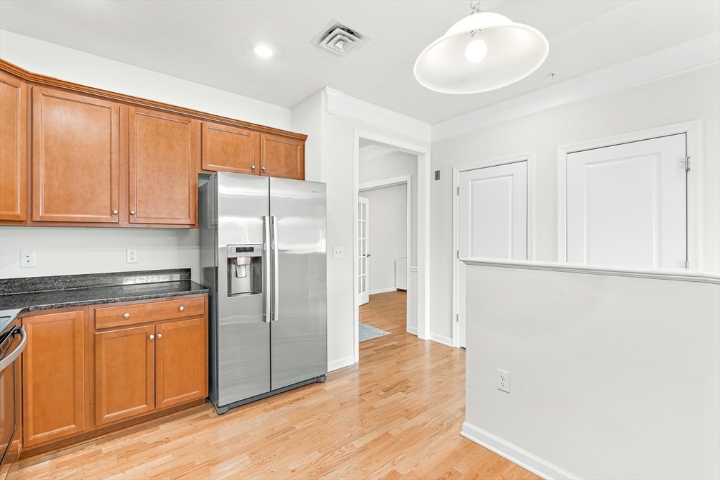 36 Abigail Way, Unit 3003 Reading, MA 01867 - Photo 20 of 42 a kitchen with stainless steel appliances a refrigerator and cabinets