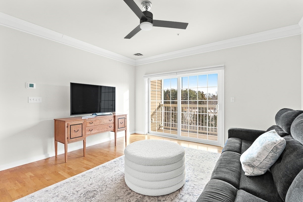 36 Abigail Way, Unit 3003 Reading, MA 01867 - Photo 25 of 42 a living room with furniture and a flat screen tv