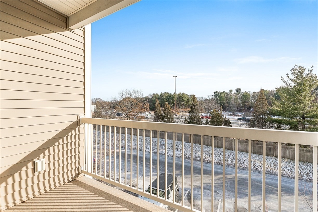 36 Abigail Way, Unit 3003 Reading, MA 01867 - Photo 26 of 42 a view of a balcony with wooden floor and fence