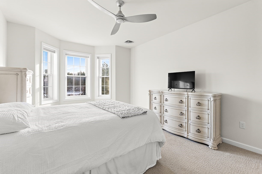 36 Abigail Way, Unit 3003 Reading, MA 01867 - Photo 27 of 42 a bedroom with a bed and a flat screen tv