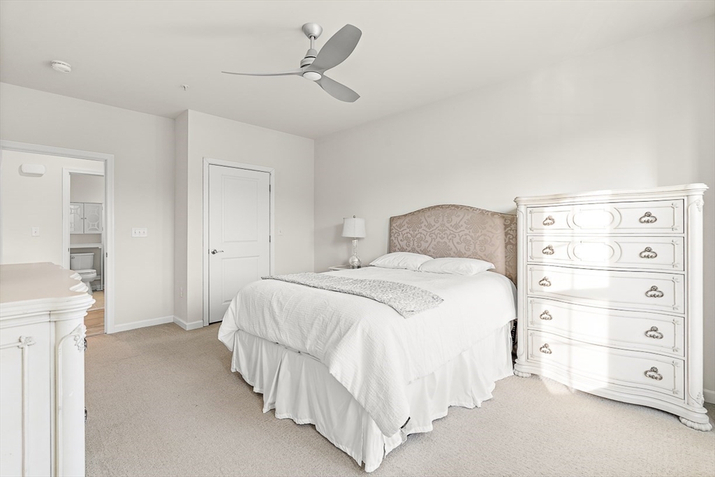 36 Abigail Way, Unit 3003 Reading, MA 01867 - Photo 29 of 42 a bedroom with a bed and a mirror