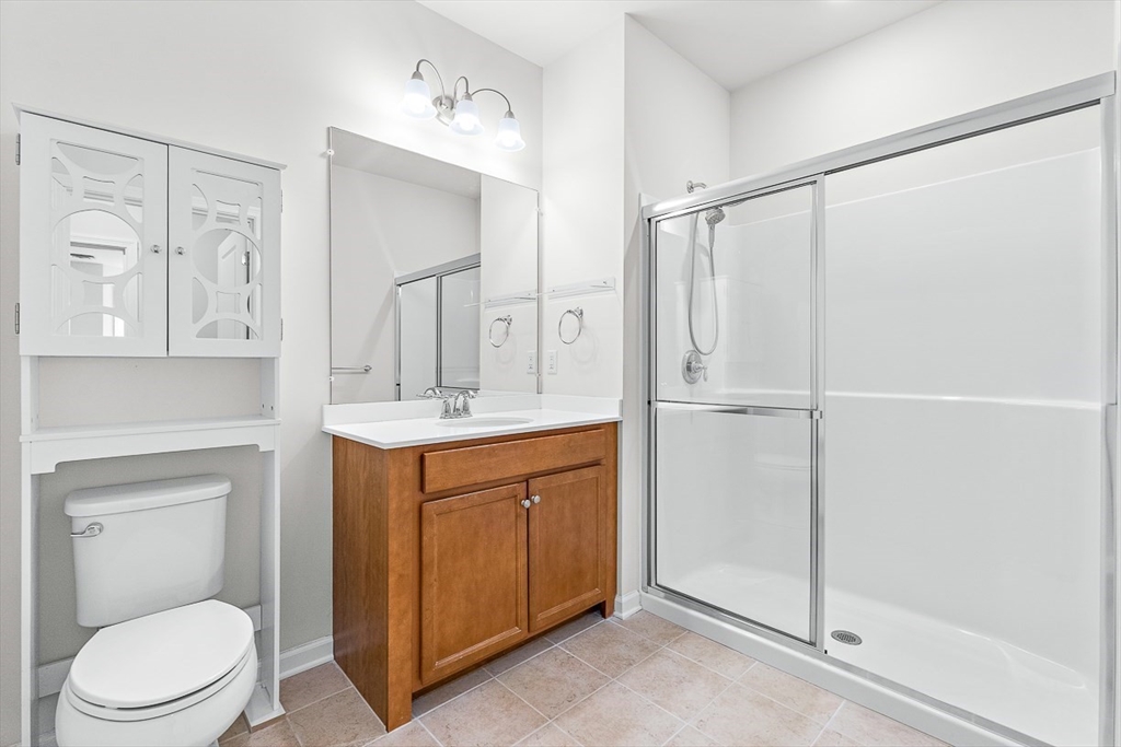 36 Abigail Way, Unit 3003 Reading, MA 01867 - Photo 33 of 42 a bathroom with a toilet a sink and a mirror