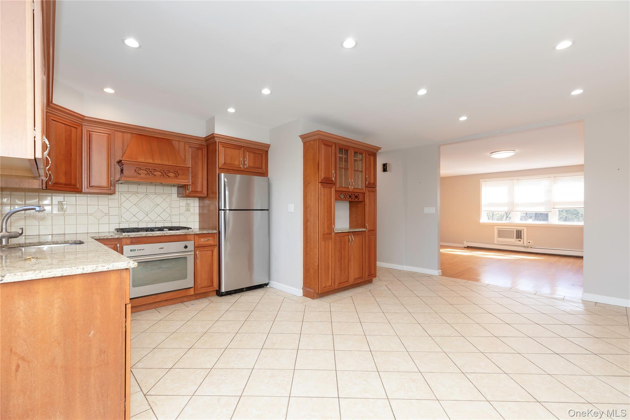 223 Ditmars Street Bronx, NY 10464 - Photo 11 of 28 a kitchen with stainless steel appliances a refrigerator sink and cabinets
