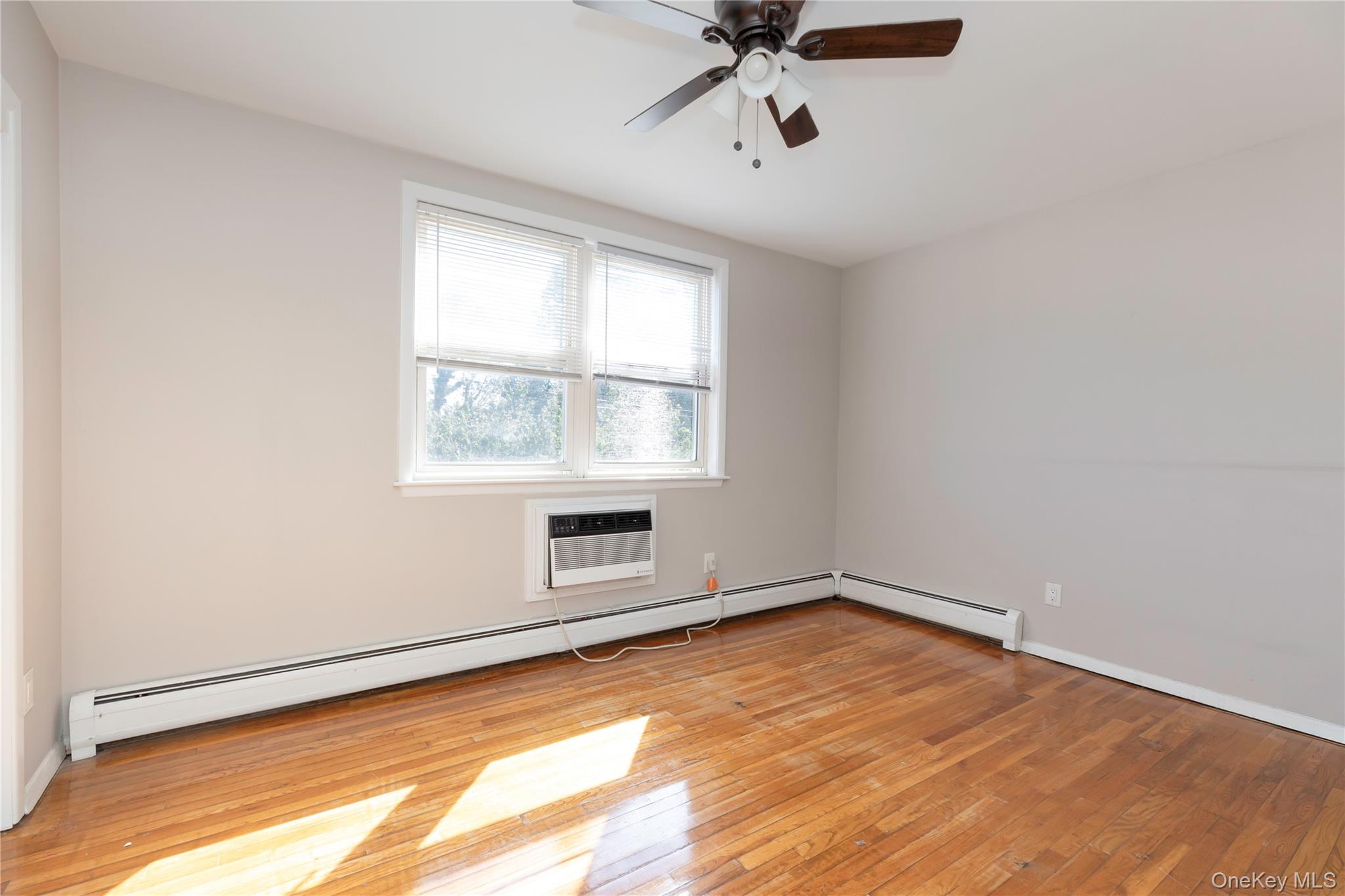 223 Ditmars Street Bronx, NY 10464 - Photo 18 of 28 an empty room with a empty space and windows