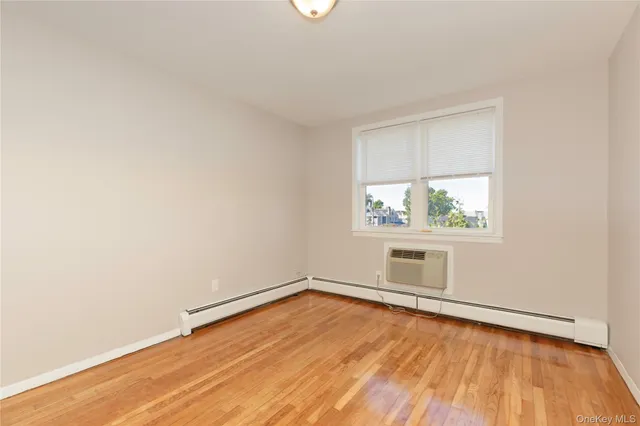 a view of room with wooden floor and fan