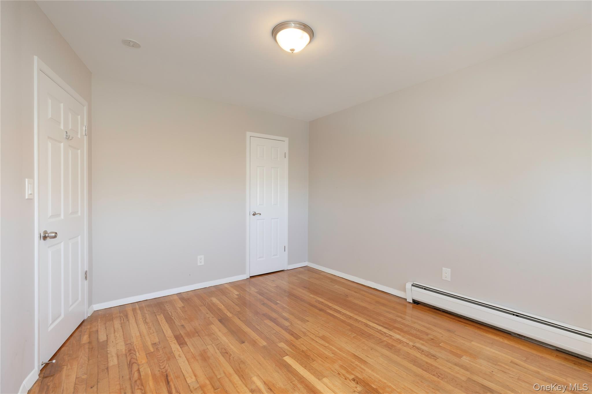 223 Ditmars Street Bronx, NY 10464 - Photo 21 of 28 a view of room with wooden floor and fan