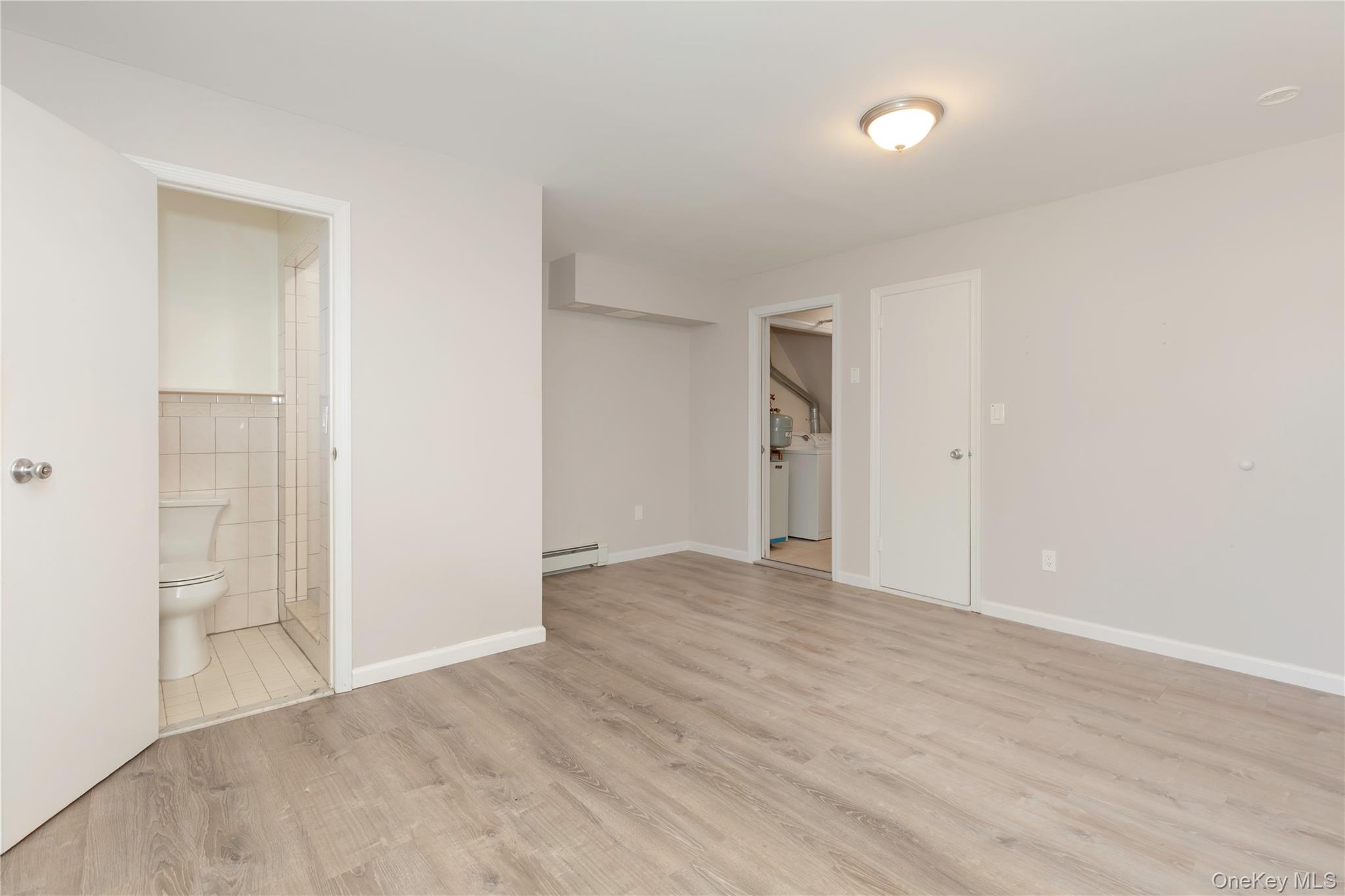 223 Ditmars Street Bronx, NY 10464 - Photo 4 of 28 wooden floor in an empty room
