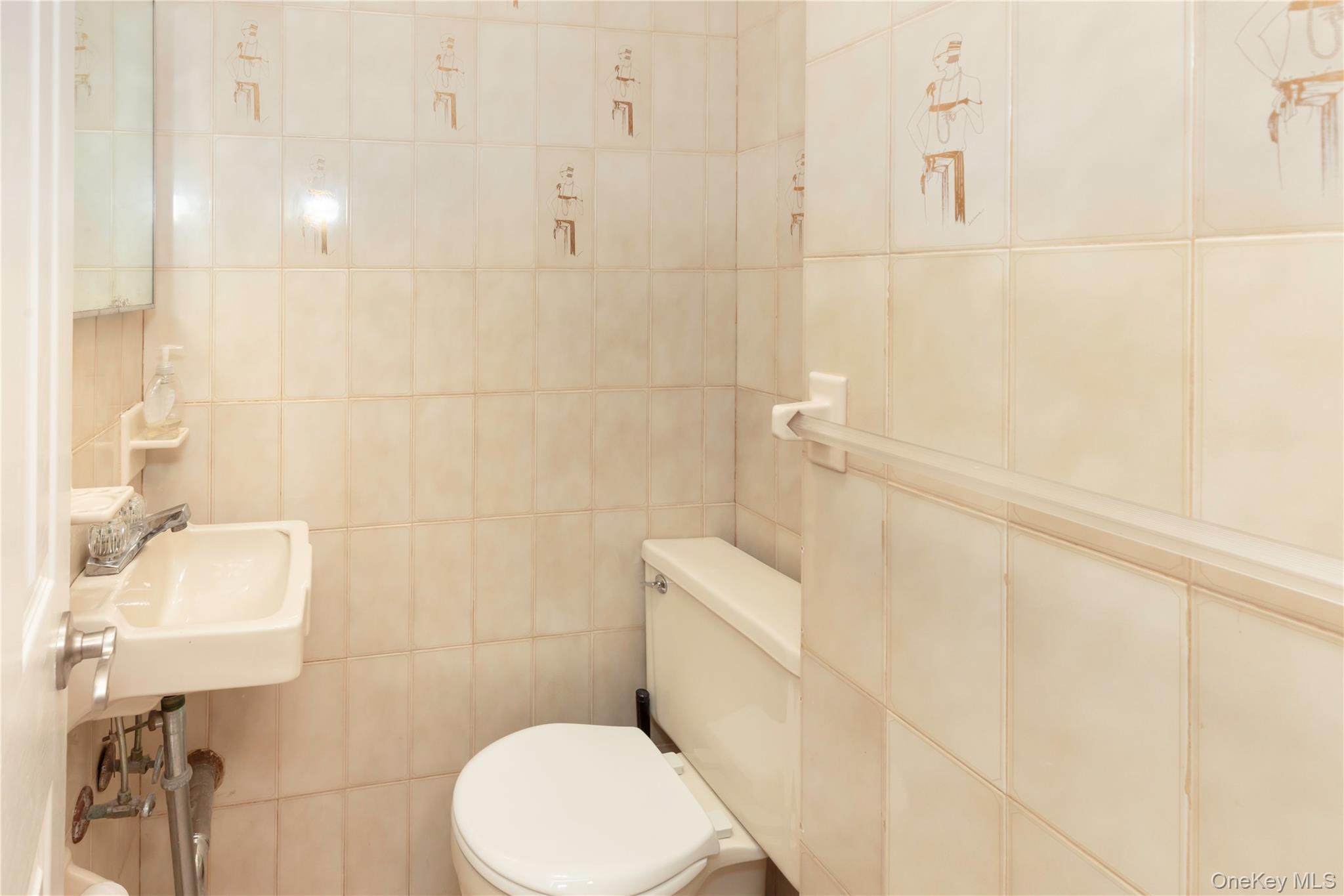 223 Ditmars Street Bronx, NY 10464 - Photo 7 of 28 a white toilet sitting next to a bathroom sink