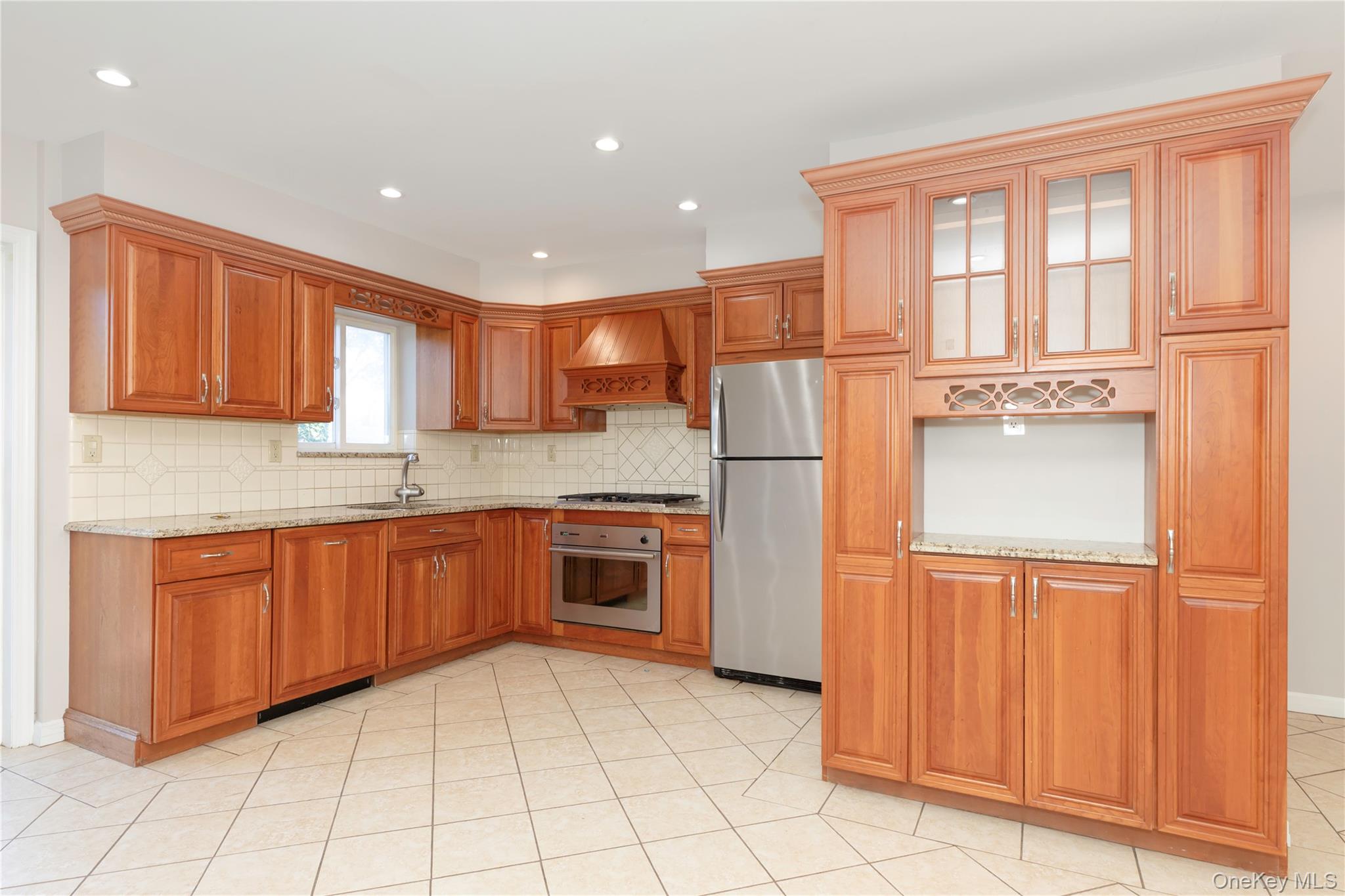 223 Ditmars Street Bronx, NY 10464 - Photo 8 of 28 a kitchen with stainless steel appliances granite countertop a refrigerator and a sink