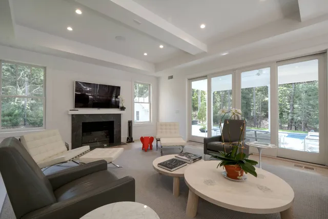 a living room with furniture a fireplace and a flat screen tv