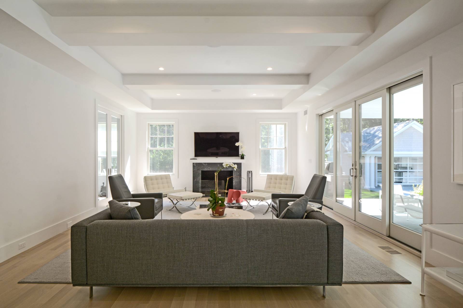 198 Bull Path East Hampton, NY 11937 - Photo 14 of 50 a living room with fireplace furniture and a large window