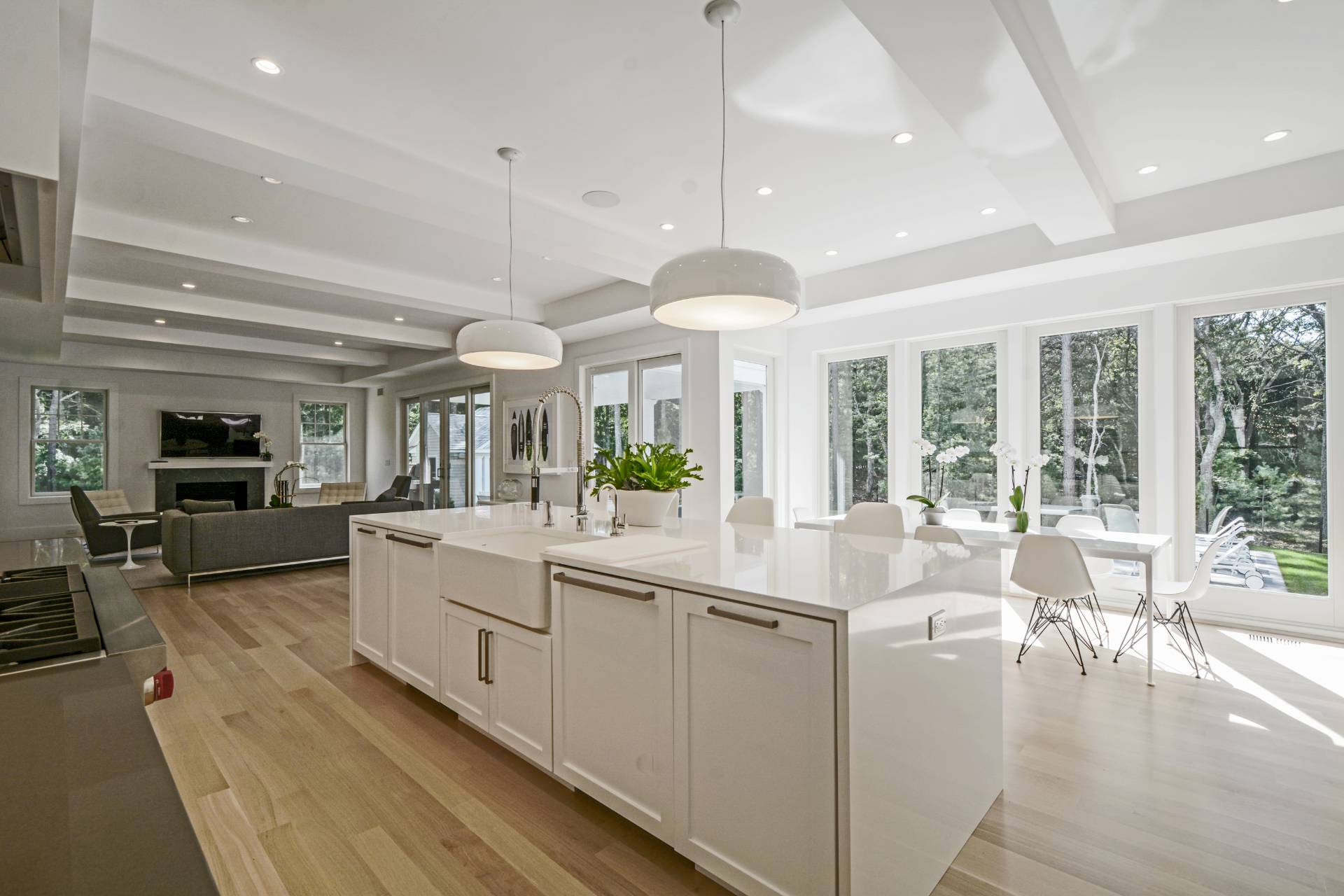 198 Bull Path East Hampton, NY 11937 - Photo 15 of 50 a large white kitchen with a large window and stainless steel appliances