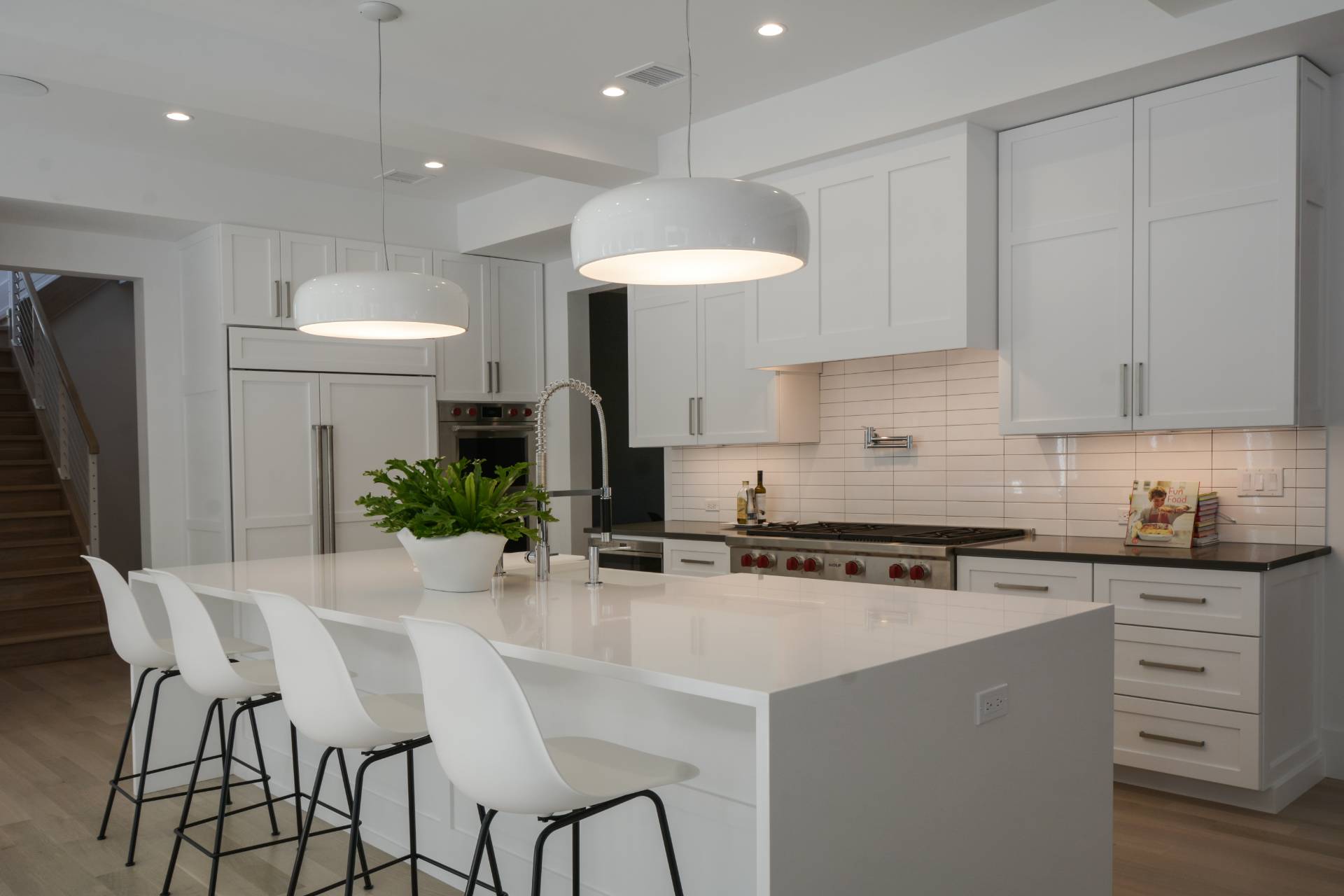 198 Bull Path East Hampton, NY 11937 - Photo 17 of 50 a kitchen with stainless steel appliances a white table chairs refrigerator and cabinets