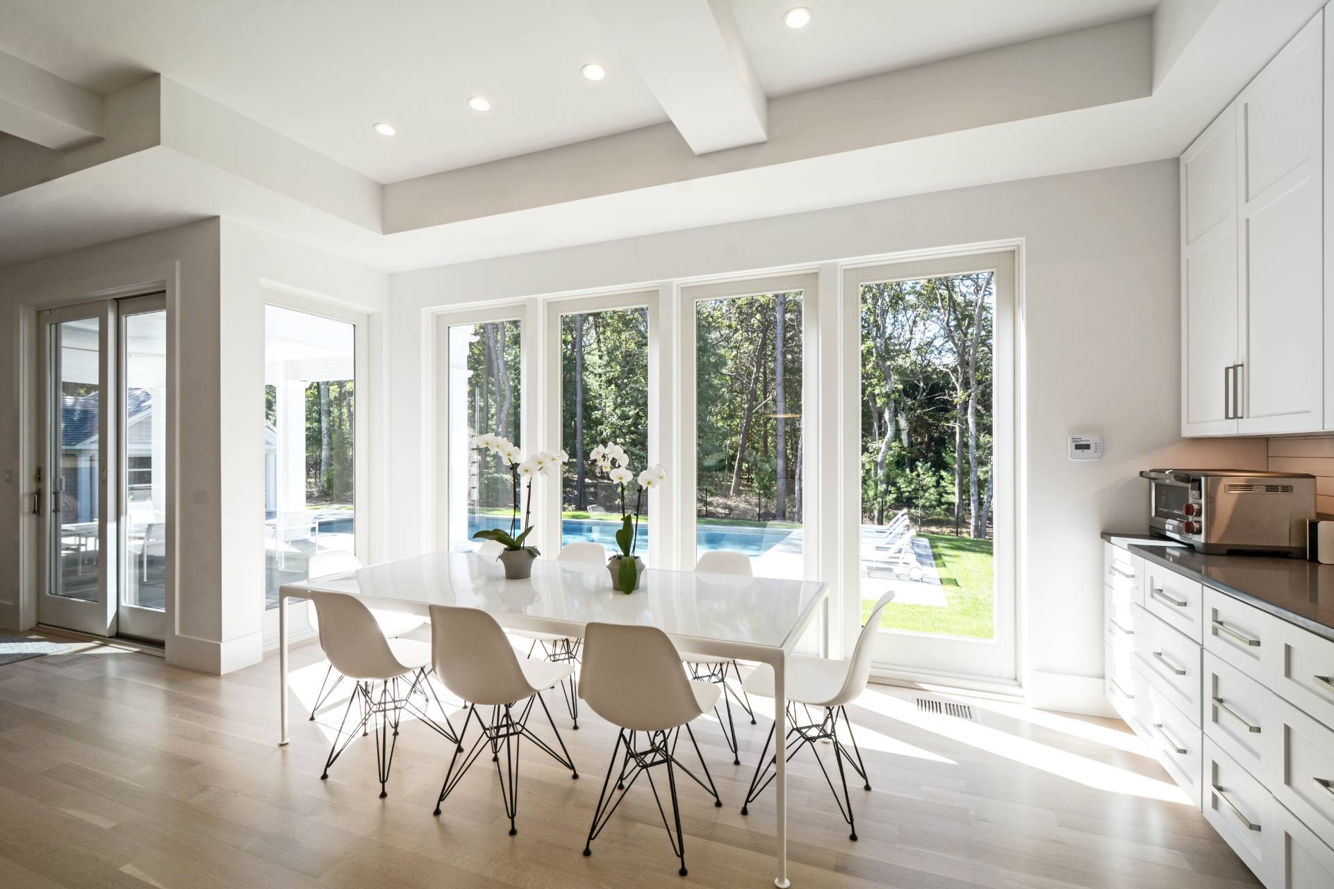198 Bull Path East Hampton, NY 11937 - Photo 18 of 50 a view of a dining room with furniture large windows and wooden floor