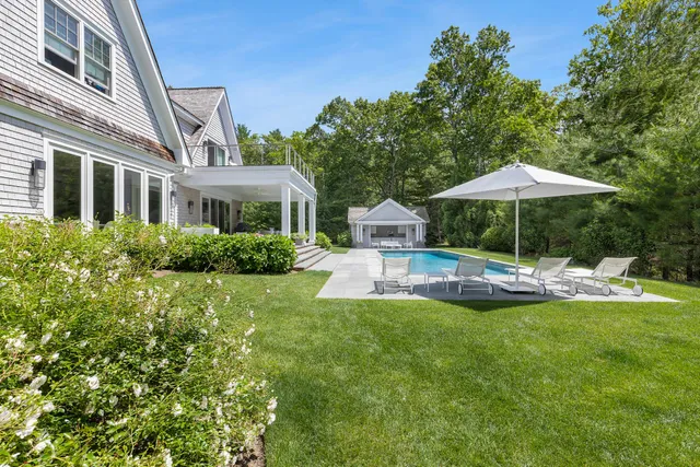 a view of a house with a yard patio and swimming pool