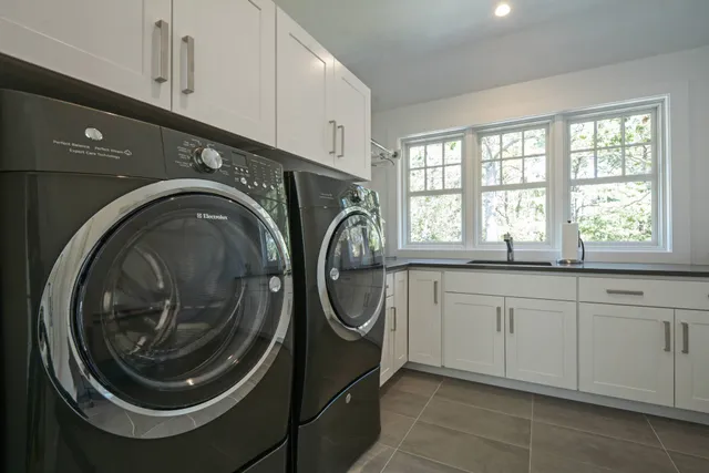 a utility room with sink dryer and washer
