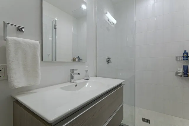 a bathroom with a sink a light fixture and a mirror