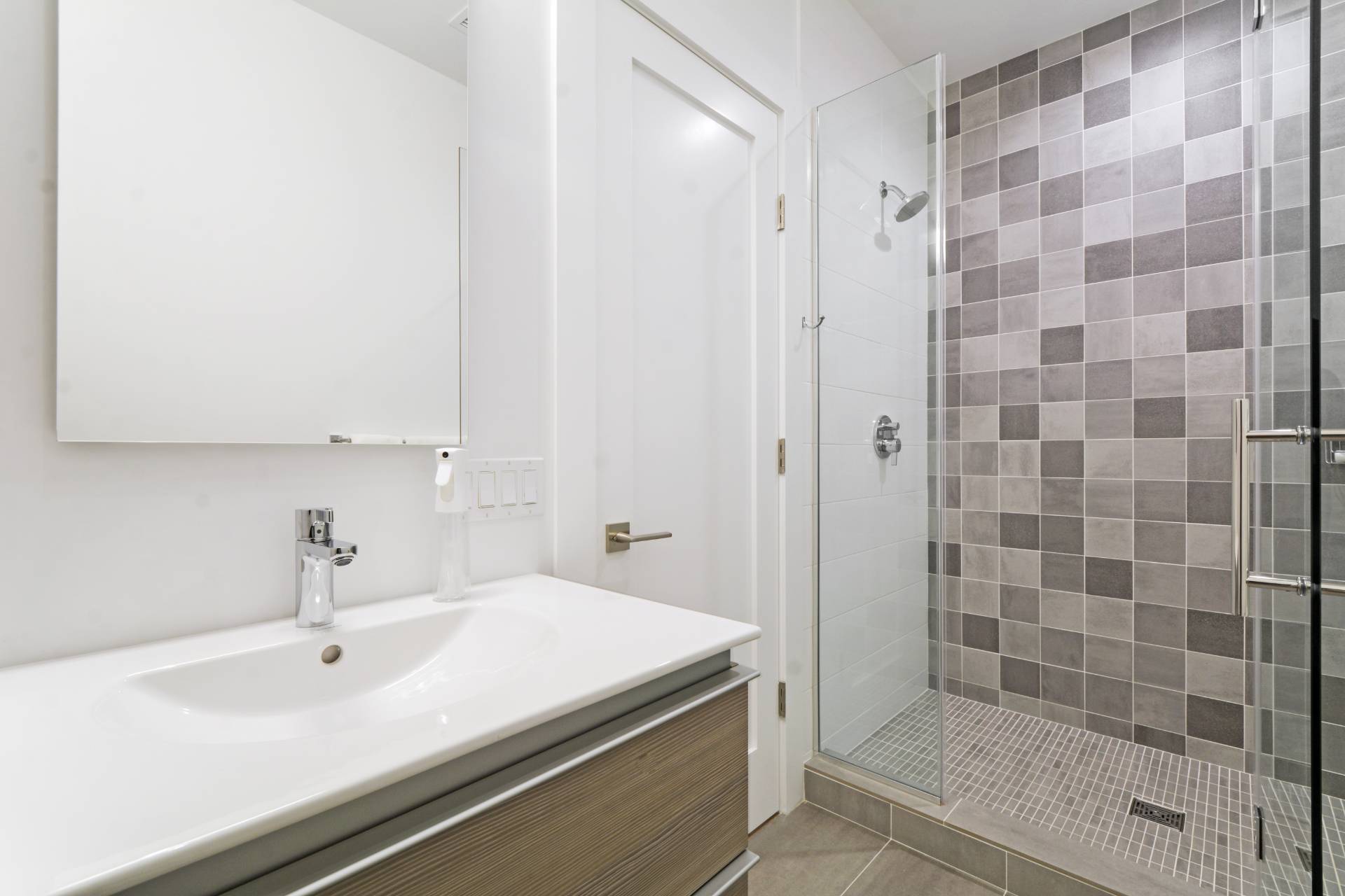 198 Bull Path East Hampton, NY 11937 - Photo 33 of 50 a bathroom with a sink a shower and a mirror