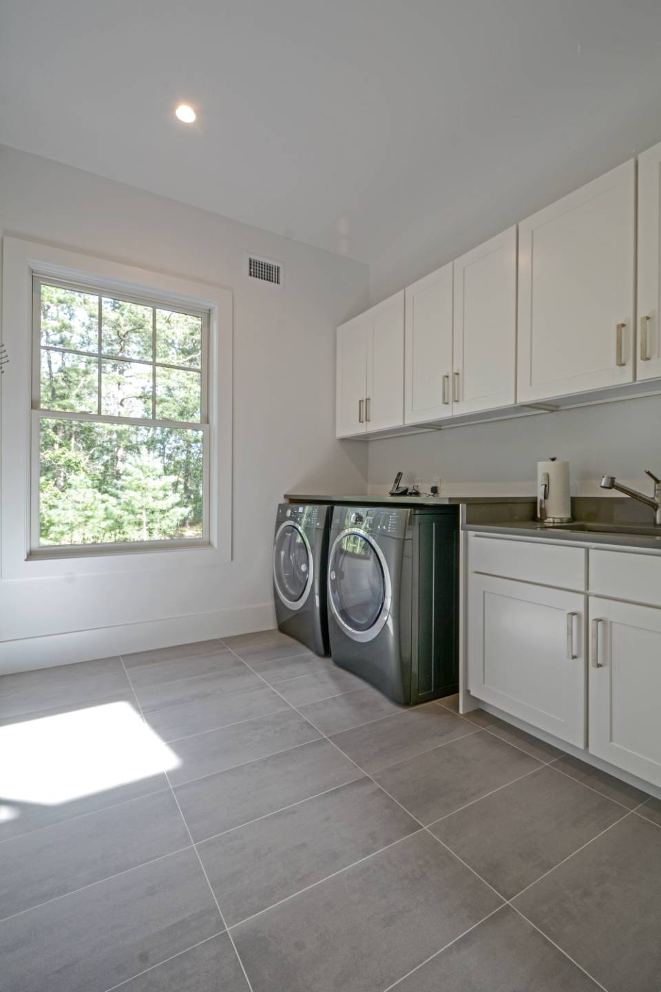 198 Bull Path East Hampton, NY 11937 - Photo 35 of 50 a utility room with cabinets washer and dryer