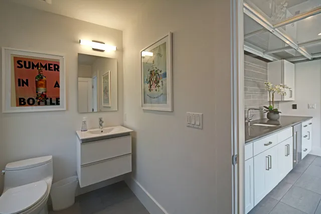 a bathroom with a toilet sink and mirror