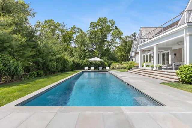 a view of a swimming pool with a yard