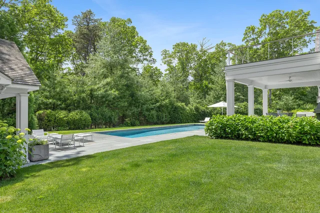 a view of a house with a backyard and a patio