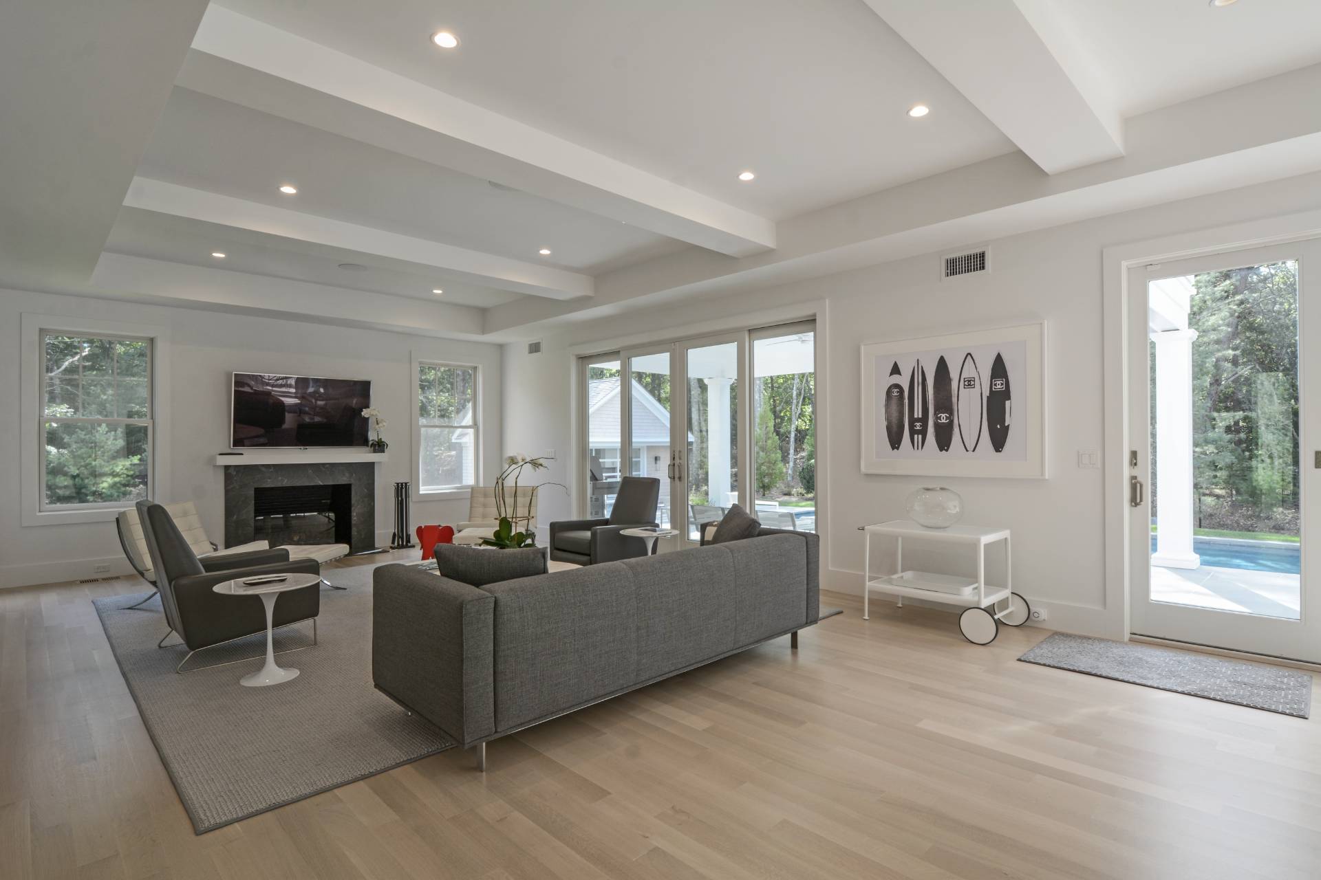 198 Bull Path East Hampton, NY 11937 - Photo 10 of 50 a living room with fireplace furniture and a large window