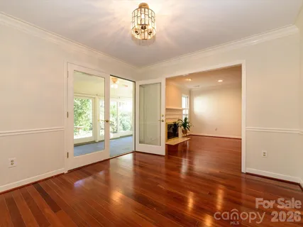 a view of an empty room with wooden floor