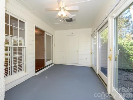 a view of empty room with wooden floor and fireplace