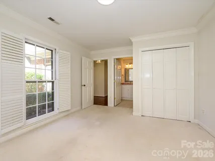 a bathroom with a toilet a sink a mirror and shower
