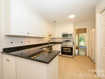 a kitchen with a sink stove and refrigerator