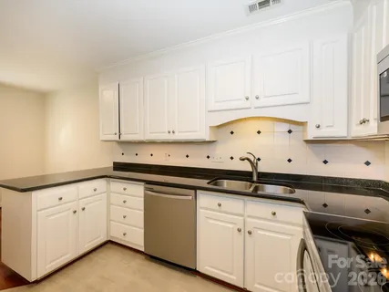 a kitchen with stainless steel appliances granite countertop a refrigerator and a stove