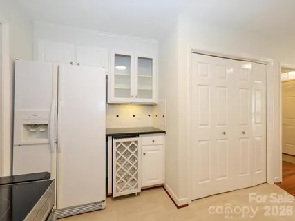 a view of empty room with wooden floor and windows