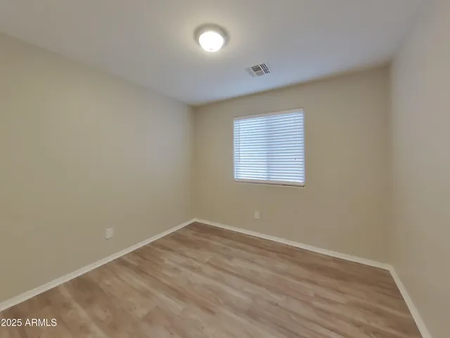 a view of an empty room and closet area
