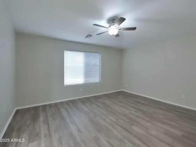 a view of empty room with window and fireplace