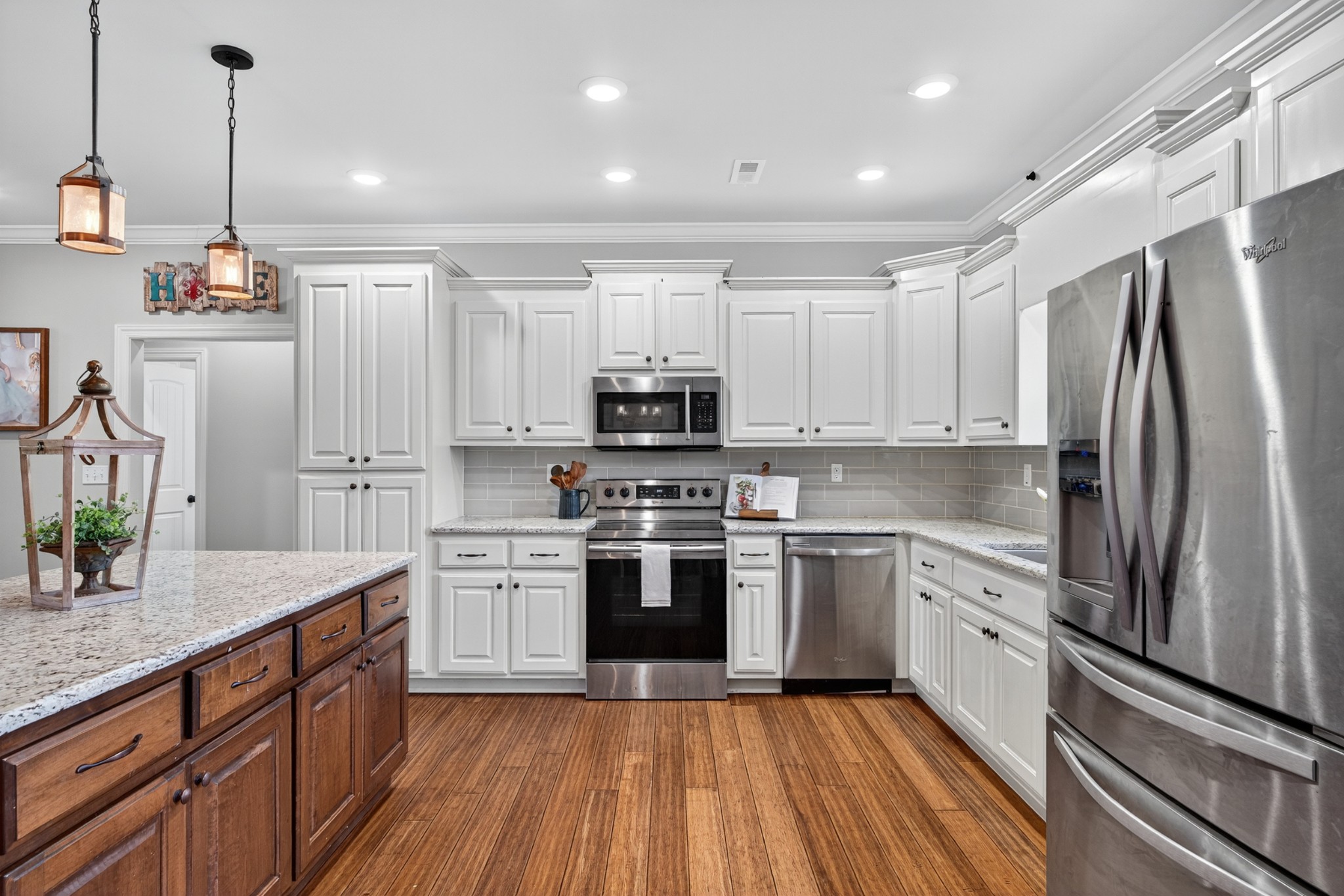 86 L Mitchell Road Kelso, TN 37348 - Photo 12 of 49 a kitchen with stainless steel appliances granite countertop a stove top oven a sink and a refrigerator