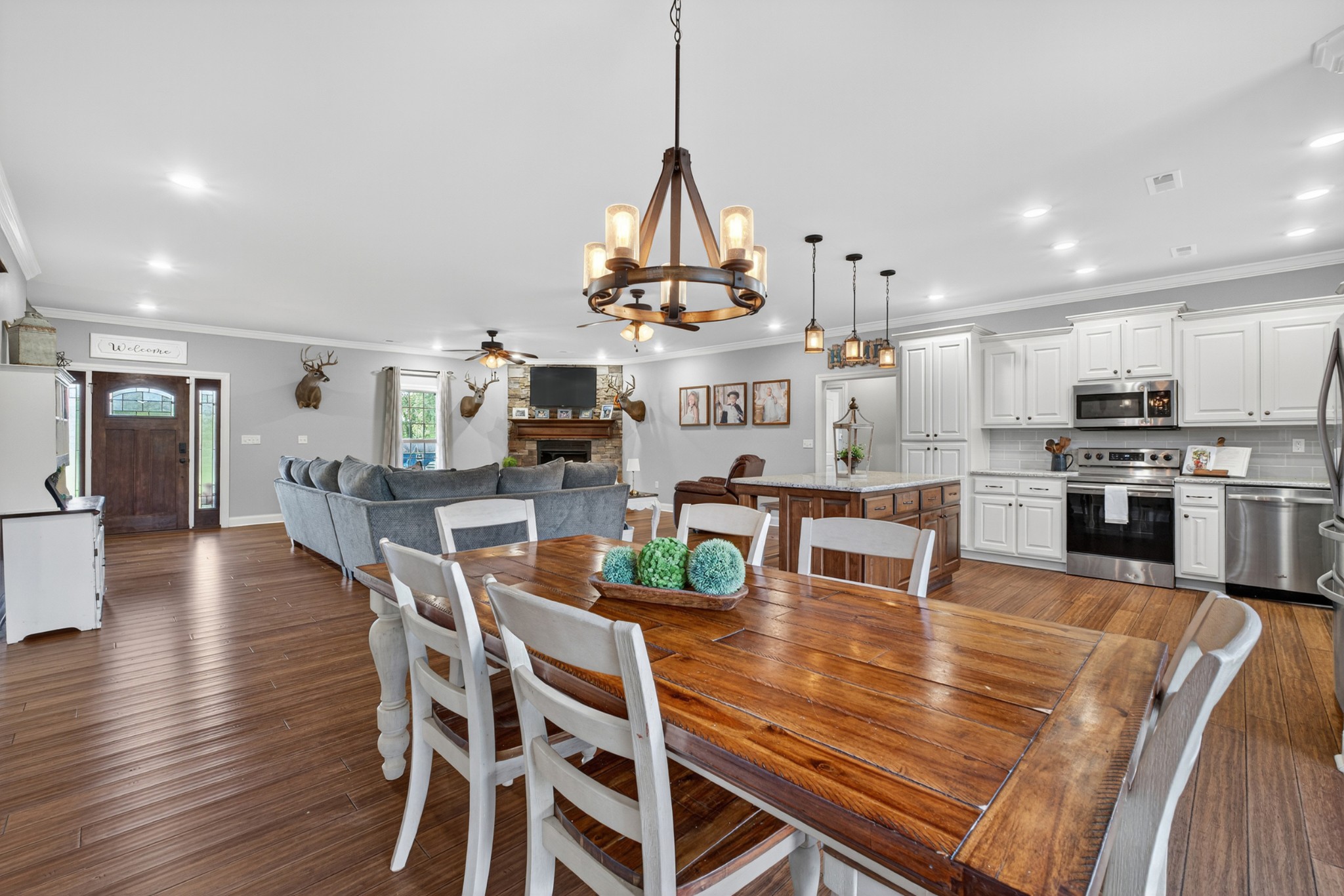 86 L Mitchell Road Kelso, TN 37348 - Photo 16 of 49 a dining room with furniture wooden floor kitchen view and a chandelier