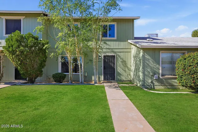 a front view of a house with a garden