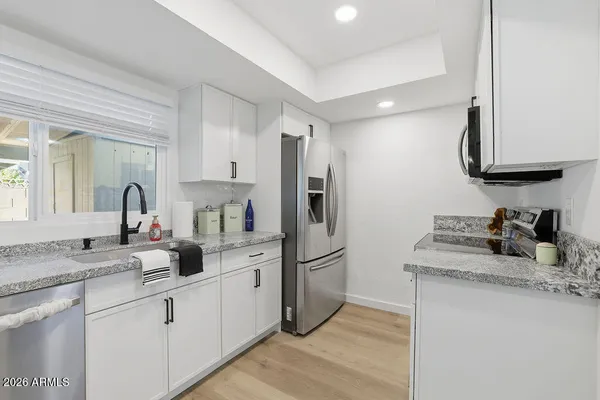 a kitchen with refrigerator and cabinets
