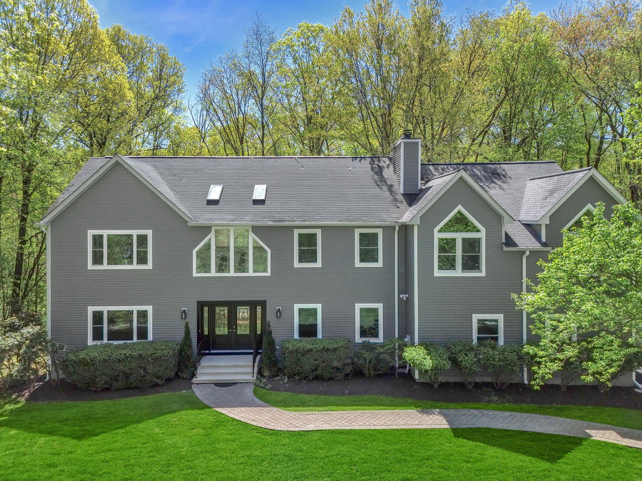 a aerial view of a house next to a yard