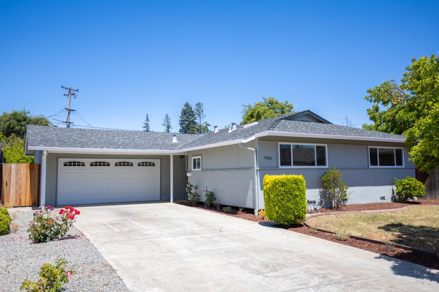 a front view of a house with a yard and a garage