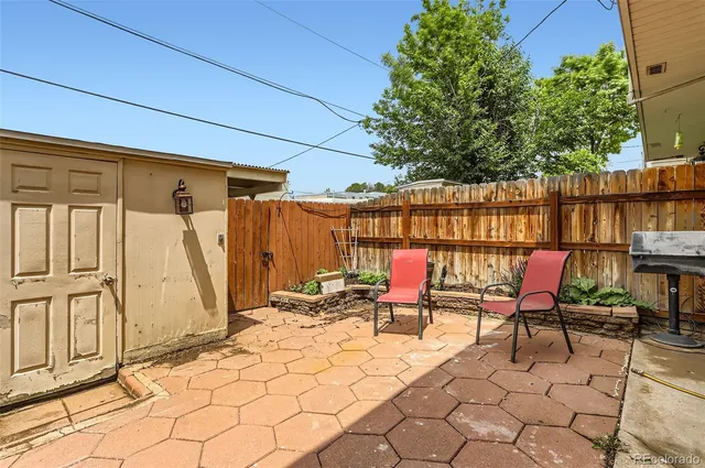 a backyard of a house with sofas