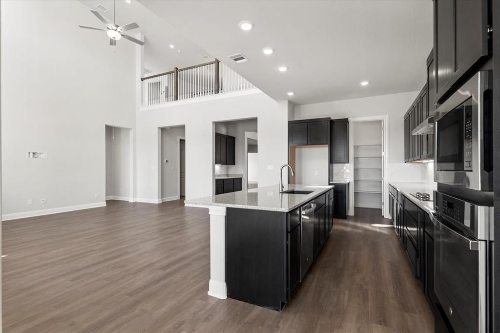 100 Plumfield Cove Georgetown, TX 78628 - Photo 40 of 40 a kitchen with kitchen island a counter top space a sink a refrigerator and a stove