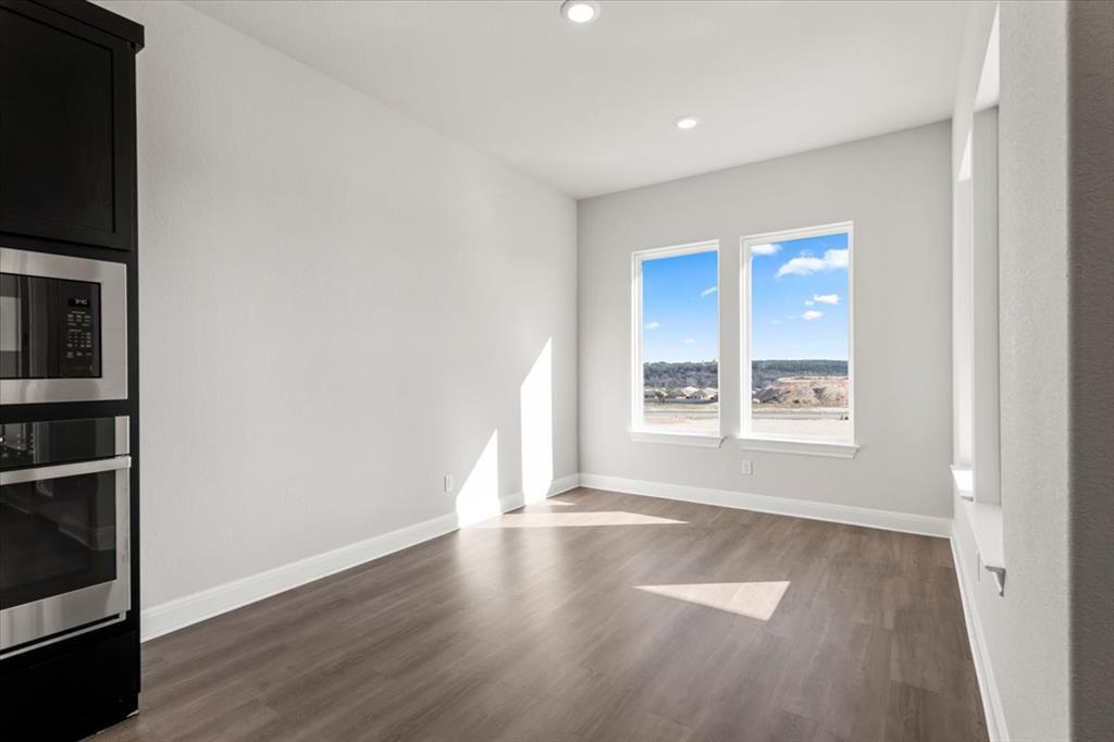 100 Plumfield Cove Georgetown, TX 78628 - Photo 17 of 40 an empty room with wooden floor and windows