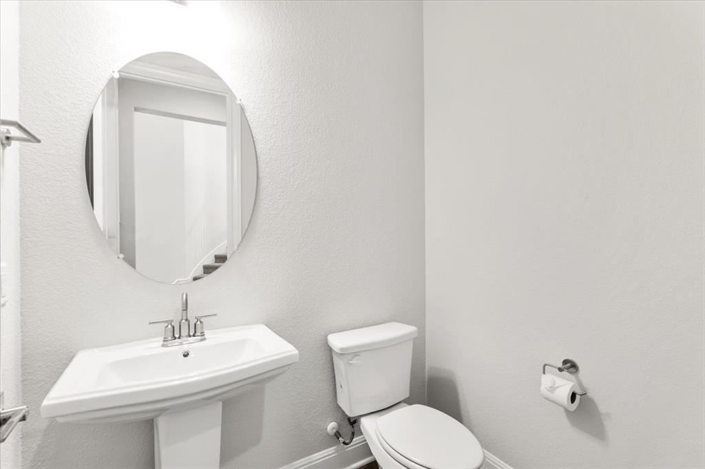 100 Plumfield Cove Georgetown, TX 78628 - Photo 28 of 40 a bathroom with a toilet a sink and mirror