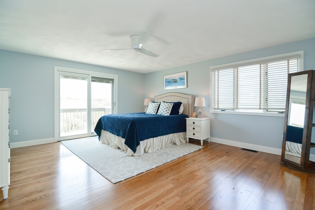 308 Phillips Road Sandwich, MA 02563 - Photo 22 of 42 a bedroom with a bed and wooden floor