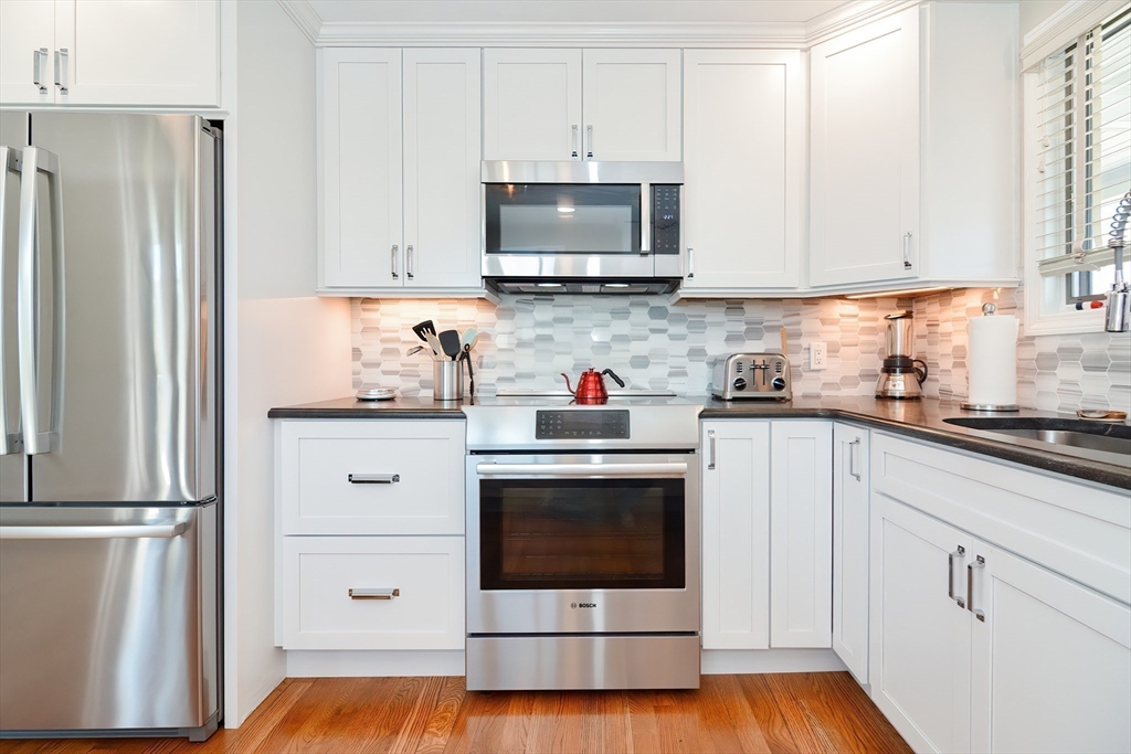 308 Phillips Road Sandwich, MA 02563 - Photo 8 of 42 a kitchen with stainless steel appliances white cabinets and a refrigerator