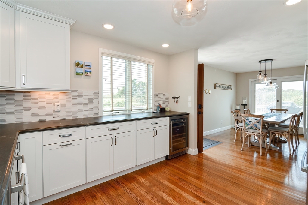 308 Phillips Road Sandwich, MA 02563 - Photo 10 of 42 a kitchen with granite countertop a stove a sink a dining table and chairs